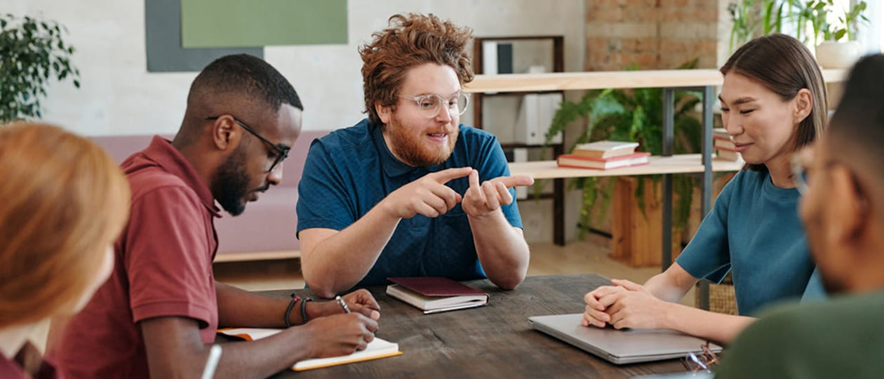 People discussing a project around a table